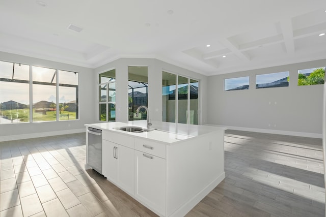 kitchen with white cabinetry, an island with sink, sink, dishwasher, and coffered ceiling