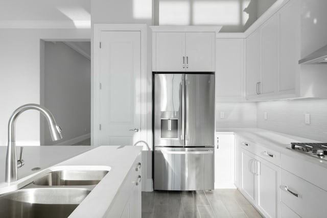 kitchen with tasteful backsplash, white cabinetry, appliances with stainless steel finishes, and sink