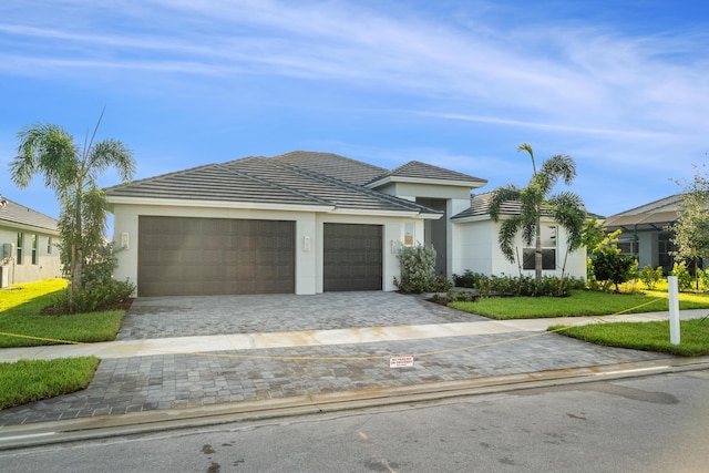 view of front of property with a garage and a front yard