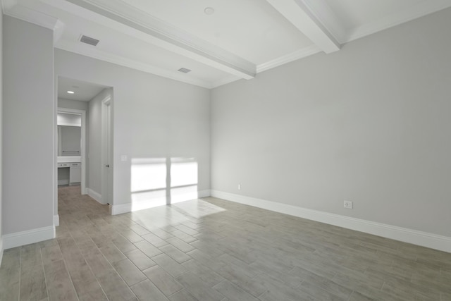 unfurnished room with crown molding, beam ceiling, and light wood-type flooring