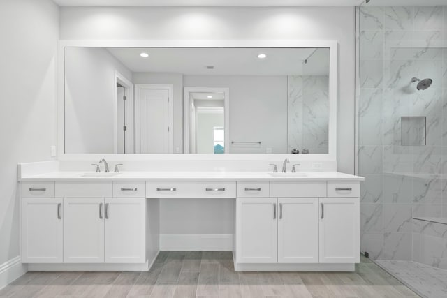 bathroom featuring vanity and a tile shower