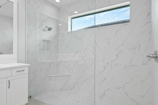 bathroom featuring vanity and a tile shower