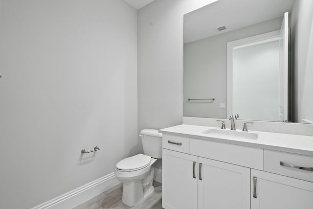 bathroom featuring vanity, toilet, and wood-type flooring