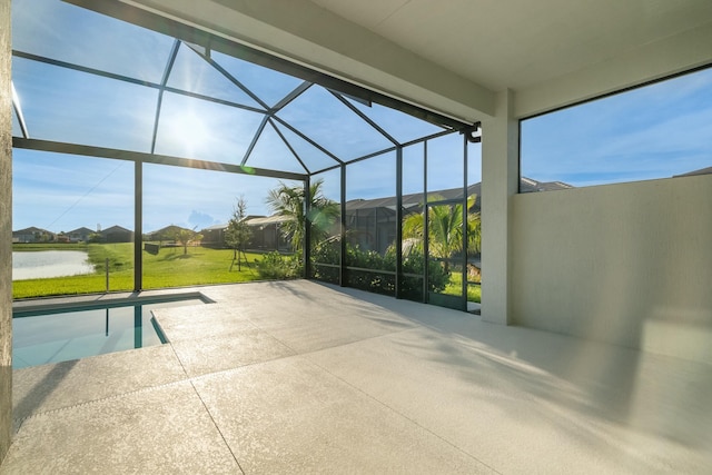 view of patio / terrace with a water view and a lanai