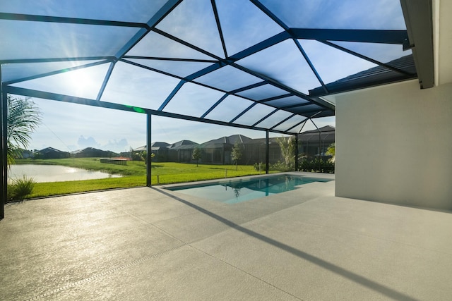 view of swimming pool featuring a water view, a yard, a lanai, and a patio