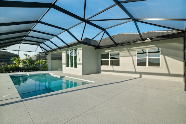 view of pool featuring a patio and glass enclosure