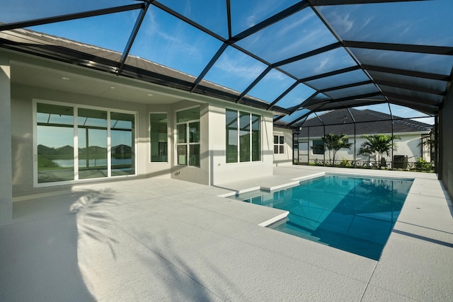 view of pool featuring a patio area and glass enclosure