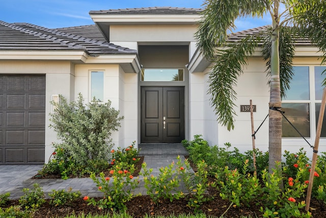 view of exterior entry featuring a garage