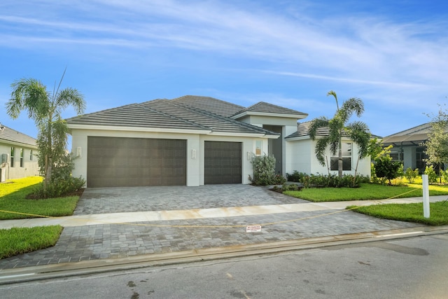 view of front of home with a garage and a front yard