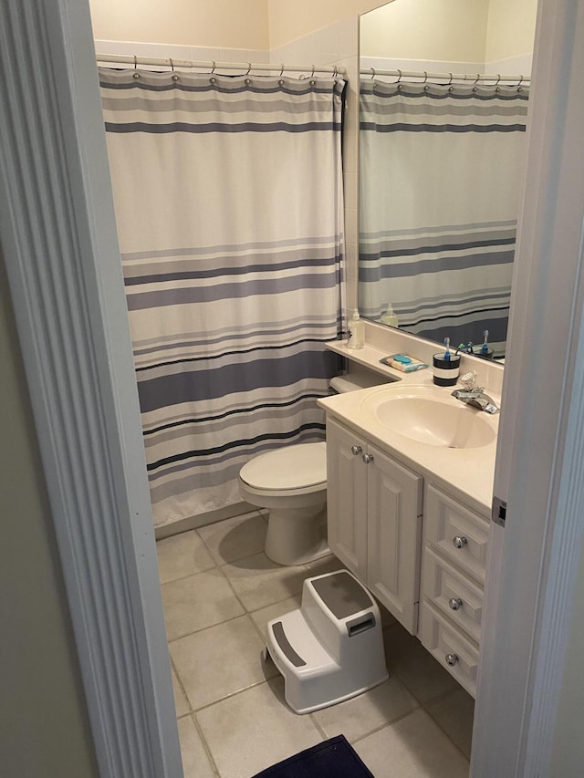 bathroom featuring vanity, toilet, and tile patterned flooring