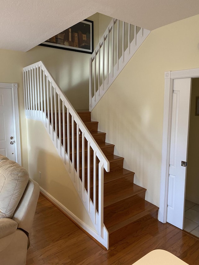 staircase featuring hardwood / wood-style floors