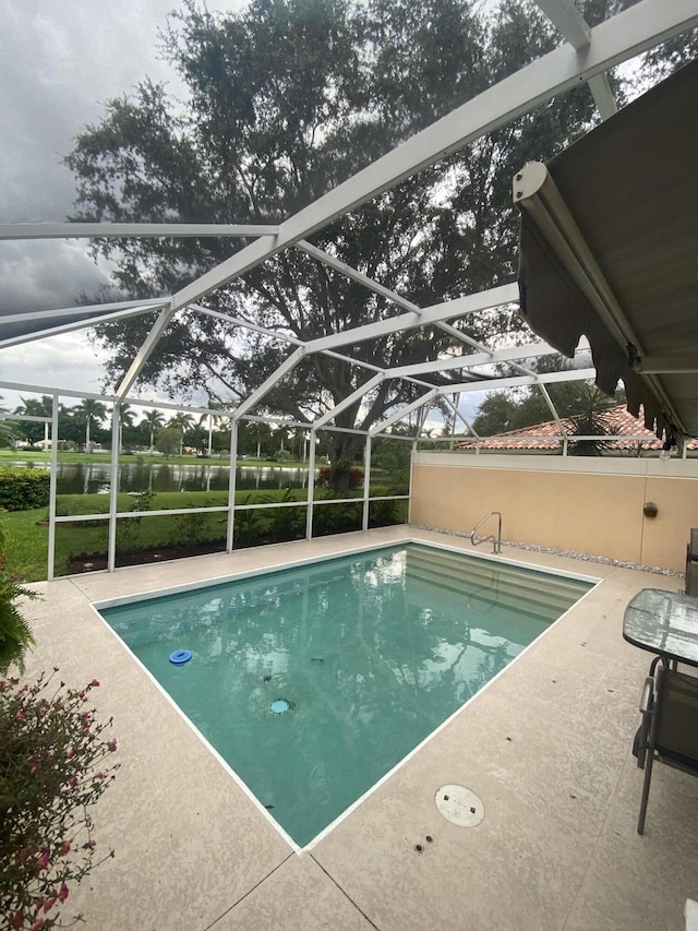 view of swimming pool with a water view, a lanai, and a patio