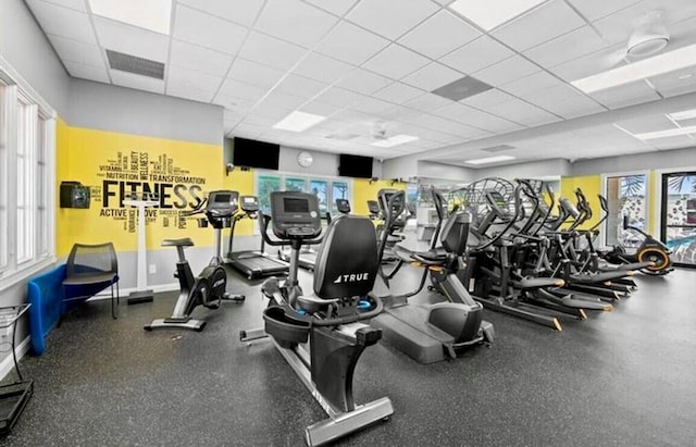 gym with a paneled ceiling