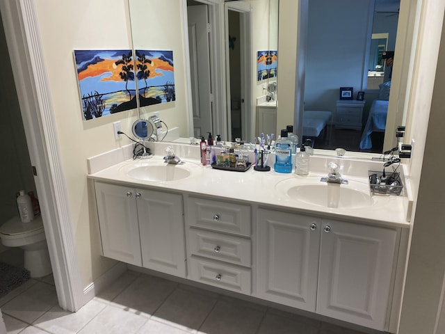 bathroom featuring vanity, tile patterned floors, and toilet