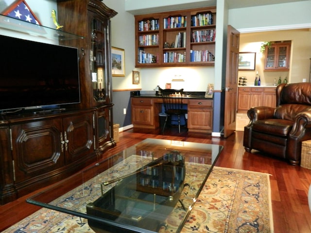 living room with dark wood-type flooring and built in desk