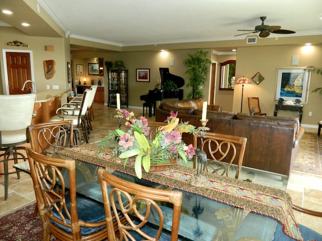 dining area with ornamental molding and ceiling fan