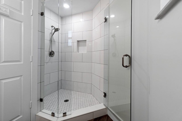 bathroom with a shower with shower door