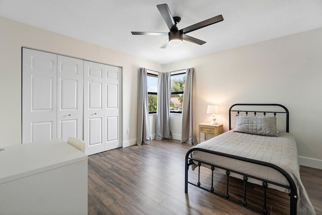 bedroom featuring ceiling fan, dark wood-type flooring, and a closet