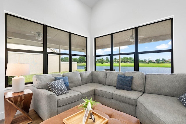 living room featuring a water view, ceiling fan, and hardwood / wood-style flooring