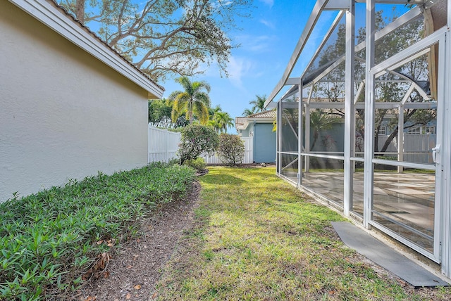 view of yard featuring glass enclosure