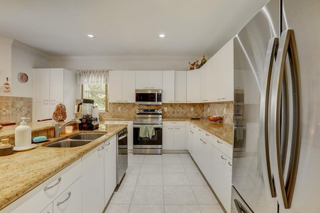 kitchen featuring stainless steel appliances, crown molding, white cabinetry, and sink