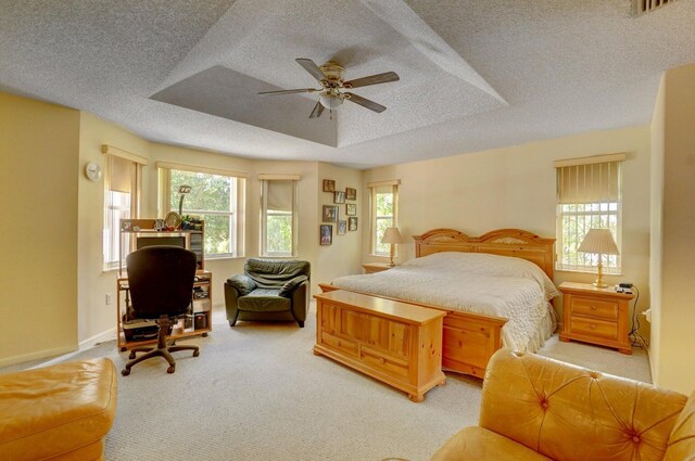 bedroom featuring ceiling fan, a closet, carpet floors, and a textured ceiling