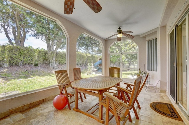 sunroom featuring ceiling fan and a wealth of natural light