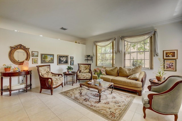 living area featuring light tile patterned floors and crown molding