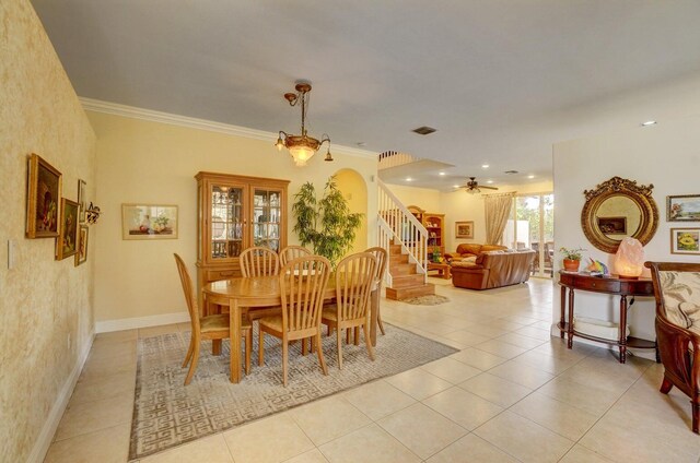 tiled living room featuring ceiling fan and crown molding