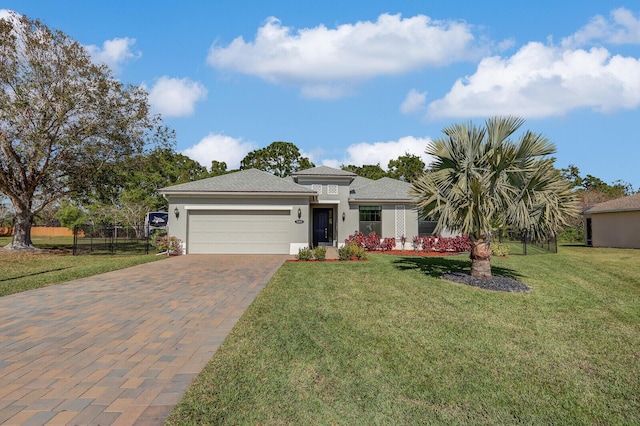 view of front of home with a garage and a front lawn