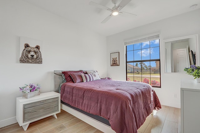 bedroom with light hardwood / wood-style floors and ceiling fan