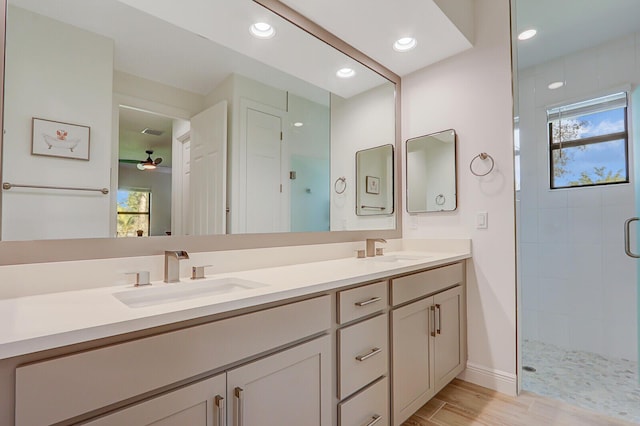 bathroom featuring vanity, hardwood / wood-style flooring, ceiling fan, and walk in shower