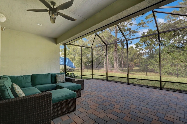 view of patio / terrace with ceiling fan, an outdoor hangout area, and glass enclosure