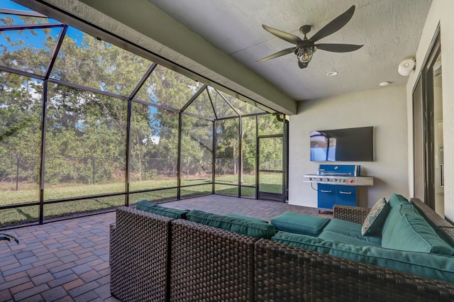 unfurnished sunroom featuring ceiling fan