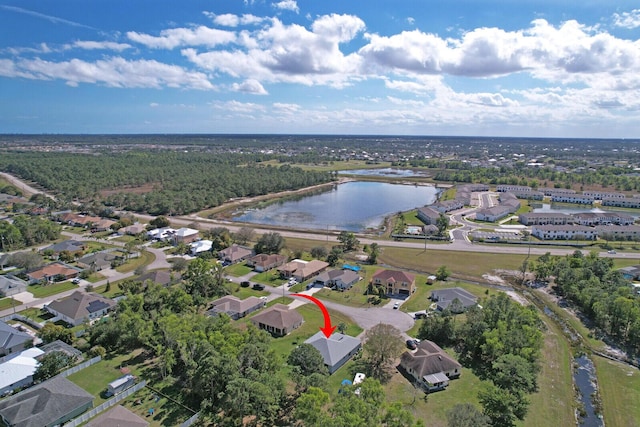 birds eye view of property with a water view