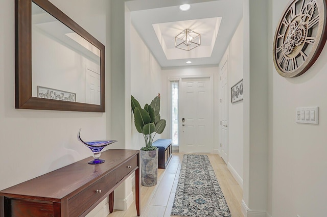 entryway with a tray ceiling