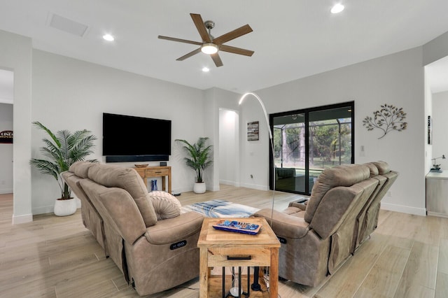 living room with ceiling fan and light hardwood / wood-style floors