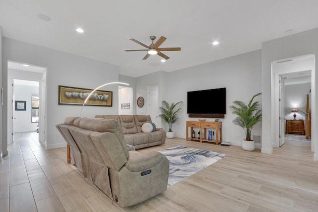 living room featuring ceiling fan and light wood-type flooring