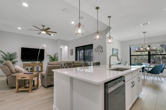 kitchen featuring sink, hanging light fixtures, dishwashing machine, a kitchen island with sink, and white cabinets