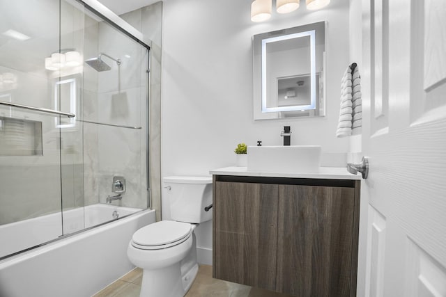 full bathroom featuring bath / shower combo with glass door, toilet, tile patterned floors, and vanity