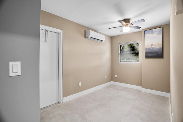 spare room with an AC wall unit and ceiling fan