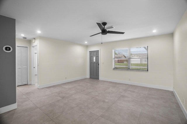 spare room with light tile patterned floors and ceiling fan