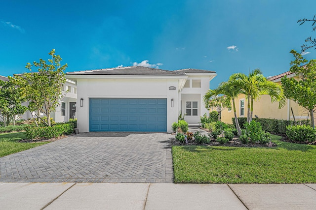 mediterranean / spanish-style home with a garage and a front lawn