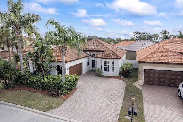 mediterranean / spanish home with a garage