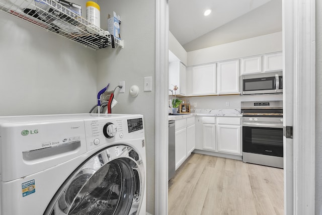 washroom featuring light wood-type flooring and washer / clothes dryer