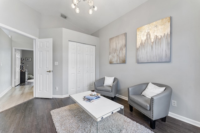 sitting room with lofted ceiling and dark hardwood / wood-style floors