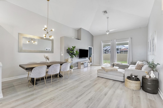 living room with light wood-type flooring, vaulted ceiling, and ceiling fan with notable chandelier