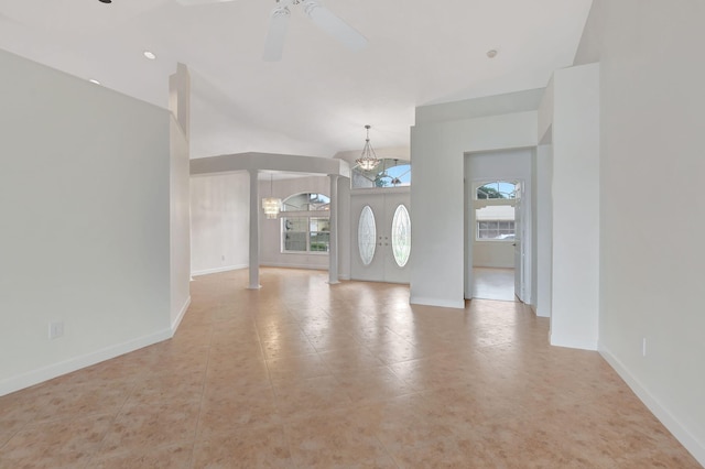 tiled entrance foyer with ceiling fan with notable chandelier and a healthy amount of sunlight