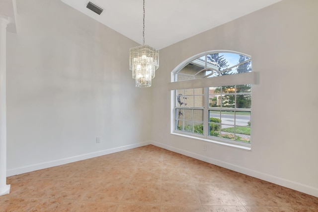 tiled spare room with an inviting chandelier and lofted ceiling