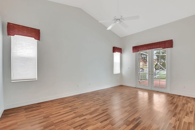 spare room featuring ceiling fan, light wood-type flooring, lofted ceiling, and french doors